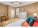 Bright bedroom with cozy bedding, dresser, and window seat at 11703 Se 91St Cir, Summerfield, FL 34491