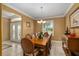 Formal dining room with wood table, chandelier, and access to entryway at 11703 Se 91St Cir, Summerfield, FL 34491