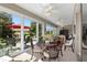 Sunroom with dining area and access to backyard at 11703 Se 91St Cir, Summerfield, FL 34491