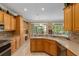 Open kitchen features an island with sink and views to Gathering room at 11703 Se 91St Cir, Summerfield, FL 34491