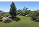 Landscaped backyard with lush greenery and patio at 11703 Se 91St Cir, Summerfield, FL 34491