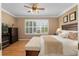 Spacious bedroom with king bed, wood floors and plantation shutters at 11703 Se 91St Cir, Summerfield, FL 34491