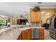 Kitchen island with double sink, stainless steel dishwasher, and breakfast bar at 11703 Se 91St Cir, Summerfield, FL 34491