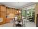 Kitchen breakfast nook with a glass table and built-in wooden cabinetry at 11703 Se 91St Cir, Summerfield, FL 34491