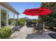Outdoor patio with seating area under a red umbrella at 11703 Se 91St Cir, Summerfield, FL 34491