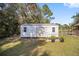 White storage shed with window and garden boxes at 14185 Sw 30Th Pl, Ocala, FL 34481