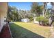 Spacious backyard with storage sheds and lush landscaping at 14185 Sw 30Th Pl, Ocala, FL 34481