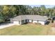 One-story home with gray roof and landscaped yard at 14185 Sw 30Th Pl, Ocala, FL 34481