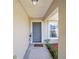Inviting front entry with gray door and welcoming doormat at 14185 Sw 30Th Pl, Ocala, FL 34481
