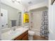 Clean bathroom with tub shower, vanity, and storage cabinet at 14185 Sw 30Th Pl, Ocala, FL 34481