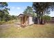 Charming small shed with wooden porch and railing at 14185 Sw 30Th Pl, Ocala, FL 34481