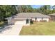 Single-story home with a gray roof and attached garage at 14185 Sw 30Th Pl, Ocala, FL 34481