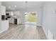 Kitchen and dining area with white cabinets and sliding glass doors at 15282 Sw 27 Ln, Ocala, FL 34481