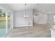 Bright dining room features light gray walls, wood-look flooring, and sliding glass doors at 15282 Sw 27 Ln, Ocala, FL 34481