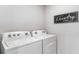 Laundry room with Whirlpool washer and dryer at 8449 Las Palmas Way, Wildwood, FL 34785