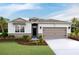 Craftsman style home with two-car garage and landscaping at 8559 Pinecrest Trl, Wildwood, FL 34785
