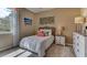 Cozy bedroom with a comfortable bed and beach-themed decor at 8559 Pinecrest Trl, Wildwood, FL 34785
