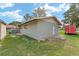 Gray workshop building with white trim and a single door at 34241 S Haines Creek Rd, Leesburg, FL 34788