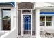 Covered entryway with a blue door and a screened porch at 6042 Topsail Rd, Lady Lake, FL 32159
