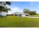 Landscaped yard with a view of the house and surroundings at 6042 Topsail Rd, Lady Lake, FL 32159