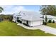 House exterior showcasing a tiled roof and landscaping at 6042 Topsail Rd, Lady Lake, FL 32159