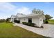 White house with a tiled roof and a paved driveway at 6042 Topsail Rd, Lady Lake, FL 32159