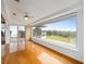 Spacious living room with hardwood floors, large window, and access to a patio at 6042 Topsail Rd, Lady Lake, FL 32159