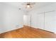 Well-lit bedroom with hardwood floors and double door closet at 6042 Topsail Rd, Lady Lake, FL 32159