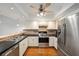 Bright kitchen boasts stainless steel appliances and hardwood floors at 6042 Topsail Rd, Lady Lake, FL 32159