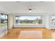 Sunlit living area with hardwood floors and scenic view at 6042 Topsail Rd, Lady Lake, FL 32159