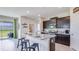 Modern kitchen with dark cabinets, granite countertops, and island with seating at 4111 Nw 48Th Terrace Rd, Ocala, FL 34482