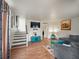 Bright living room with hardwood floors, a comfy sectional sofa, and a large TV at 712 Sw 10Th Ave, Ocala, FL 34471
