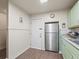 Bright kitchen features stainless steel appliances and light green cabinets at 712 Sw 10Th Ave, Ocala, FL 34471