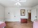 Bedroom with hardwood floors, ceiling fan, and ample closet space at 712 Sw 10Th Ave, Ocala, FL 34471