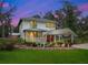 Two-story house with a covered porch and landscaping at 712 Sw 10Th Ave, Ocala, FL 34471