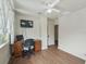 Home office features wood desk, chair, and security monitor at 712 Sw 10Th Ave, Ocala, FL 34471