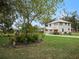 Landscaped yard with tropical plants and house in background at 712 Sw 10Th Ave, Ocala, FL 34471