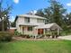 Two-story house featuring a metal roof, and mature landscaping at 712 Sw 10Th Ave, Ocala, FL 34471