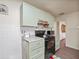 View of kitchen with light green cabinets and granite countertops at 712 Sw 10Th Ave, Ocala, FL 34471