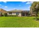 Backyard view of home with screened patio at 8386 Sw 82Nd Cir, Ocala, FL 34481