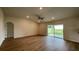 Spacious living room with sliding glass doors and hardwood floors at 4503 Sw 132Nd St, Ocala, FL 34473