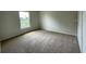 Bright bedroom with neutral carpeting and large window at 4503 Sw 132Nd St, Ocala, FL 34473