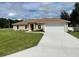 Newly constructed home with a well-manicured lawn and driveway at 4503 Sw 132Nd St, Ocala, FL 34473