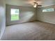Spacious carpeted bedroom with large window and ceiling fan at 4503 Sw 132Nd St, Ocala, FL 34473