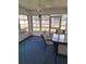 Sunroom with glass windows, ceiling fan, and seating area at 10970 Sw 69Th Cir, Ocala, FL 34476
