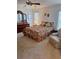 Spacious bedroom with floral bedding, a dresser, and a comfortable armchair at 10970 Sw 69Th Cir, Ocala, FL 34476