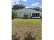 Home's backyard with grassy lawn and screened enclosure at 10970 Sw 69Th Cir, Ocala, FL 34476