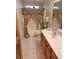 Bathroom with tub, shower, and vanity with a light-colored countertop at 10970 Sw 69Th Cir, Ocala, FL 34476