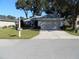 Single-story home with attached garage and well-manicured lawn at 10970 Sw 69Th Cir, Ocala, FL 34476