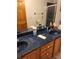 Double vanity bathroom with blue countertop and a large shower at 10970 Sw 69Th Cir, Ocala, FL 34476